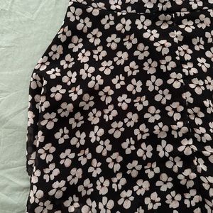 Skater black skirt with flowers print. It sizes really small